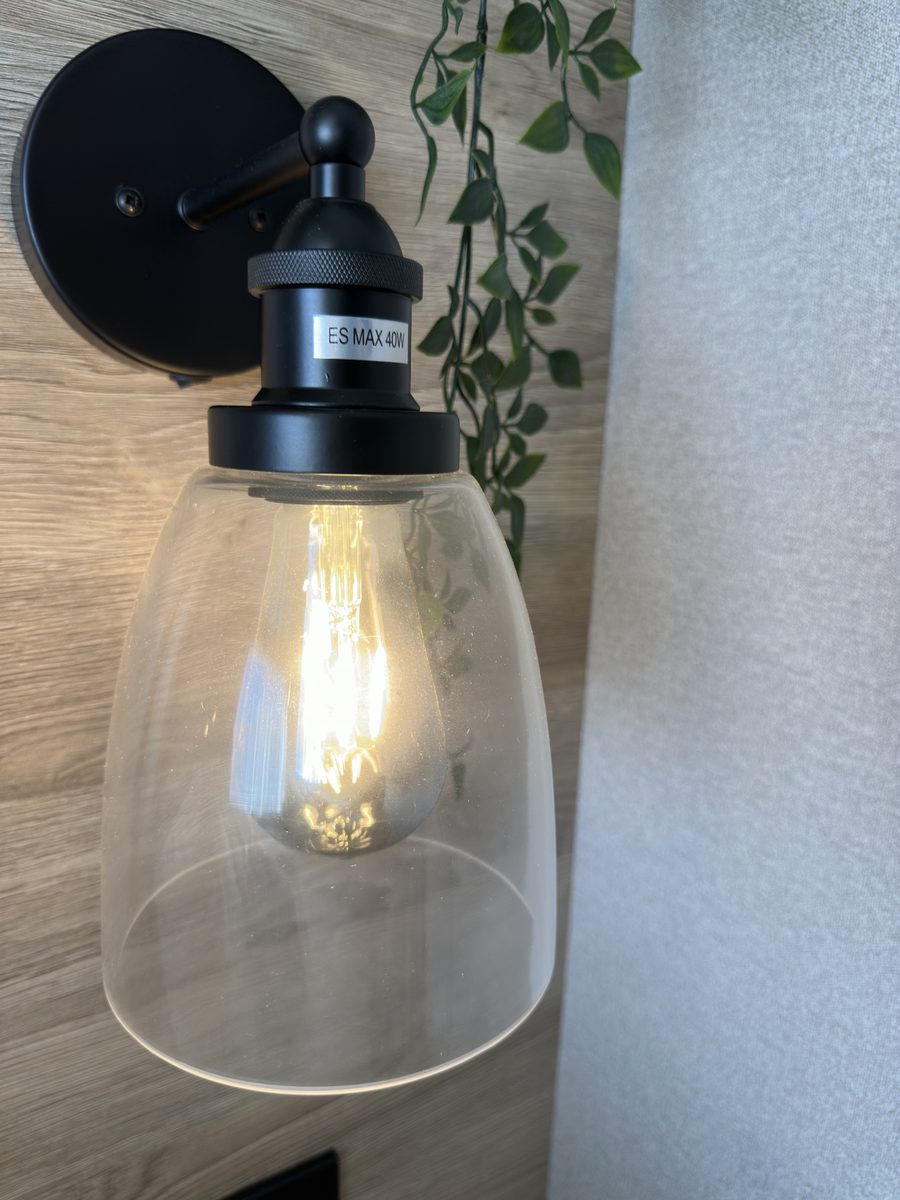 The Ingleton, a black wall light with a clear glass shade