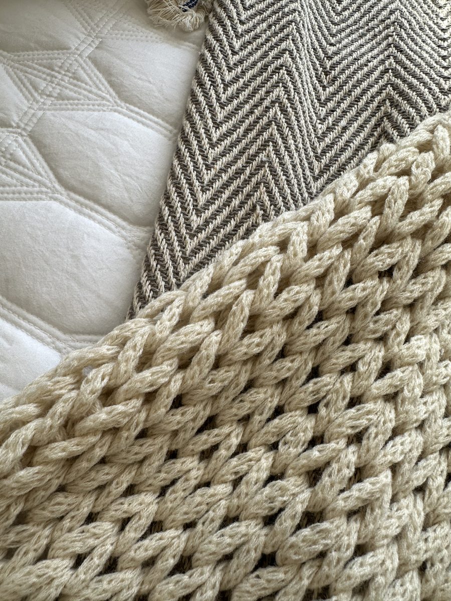 The Edmonton, a cable knit throw over herringbone