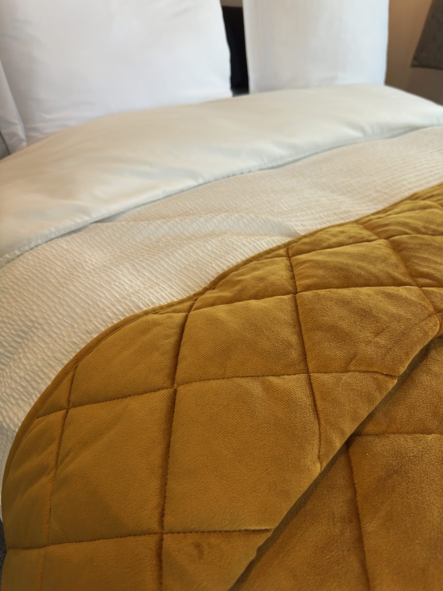 The Margaux, a quilted mustard throw