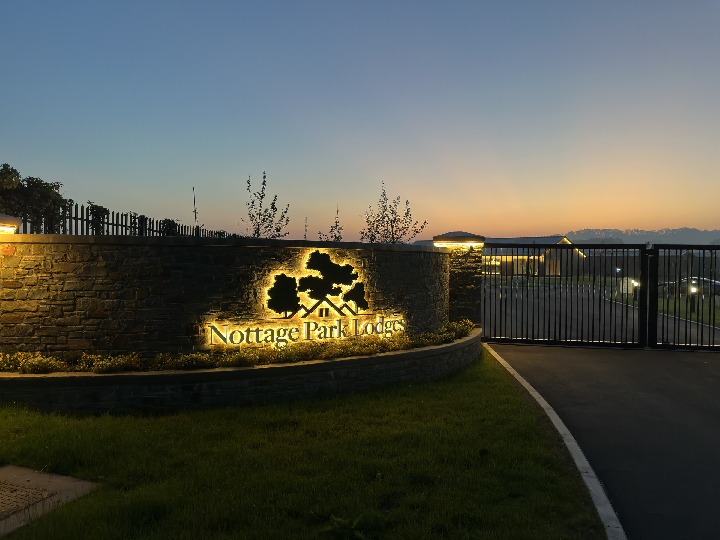 The entrance to Nottage Park Lodges at dusk, lit