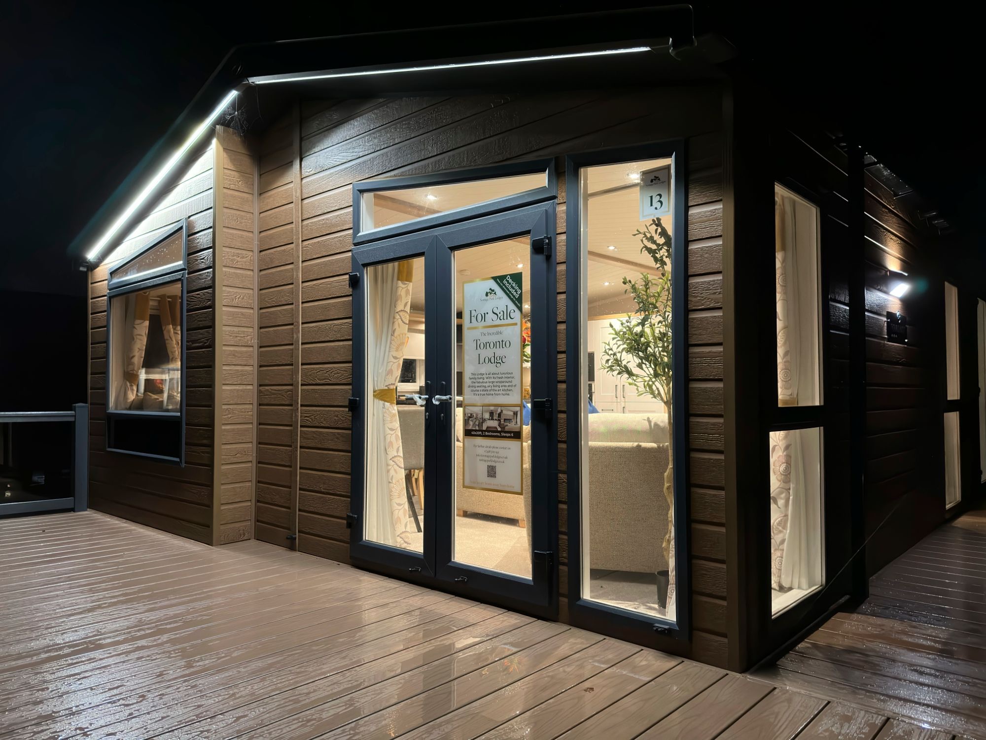 The Toronto on pitch 13 at night, lit inside, on wet decking