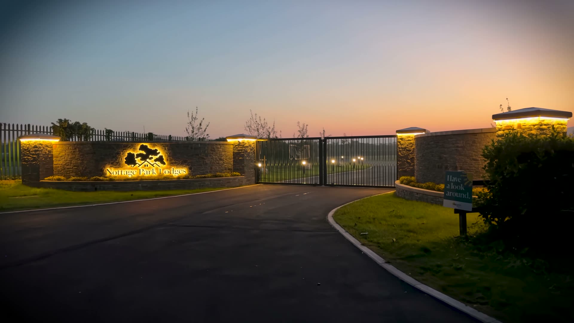 The lit entrance to Nottage Park Lodges at dusk