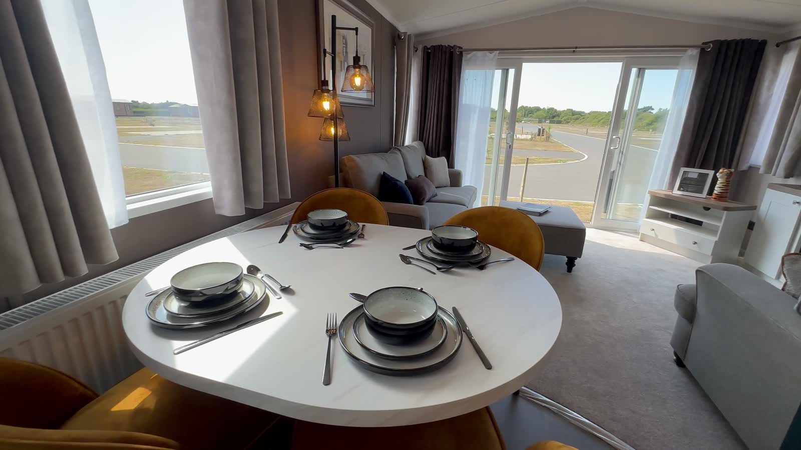 The Margaux, the dining table laid, with the doors open onto the park beyond